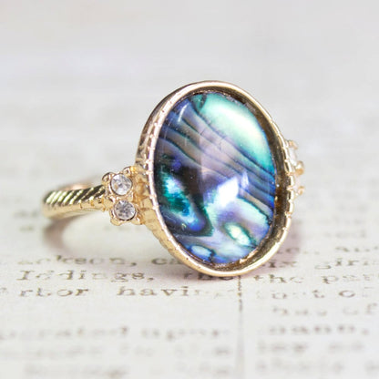Vintage gold electroplated ring with oval blue-green abalone shell and clear Swarovski crystal accents on a twisted rope band