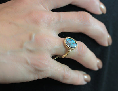 Vintage gold electroplated ring with oval blue-green abalone shell and clear Swarovski crystal accents on a twisted rope band